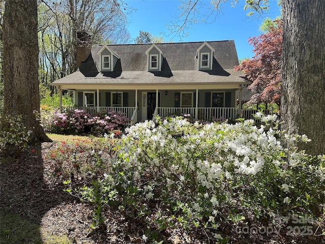 new england style home with a porch