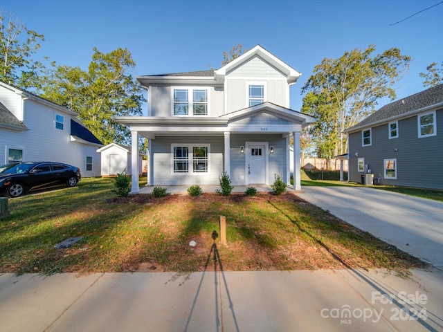 traditional-style house with central AC, a front lawn, a porch, and board and batten siding