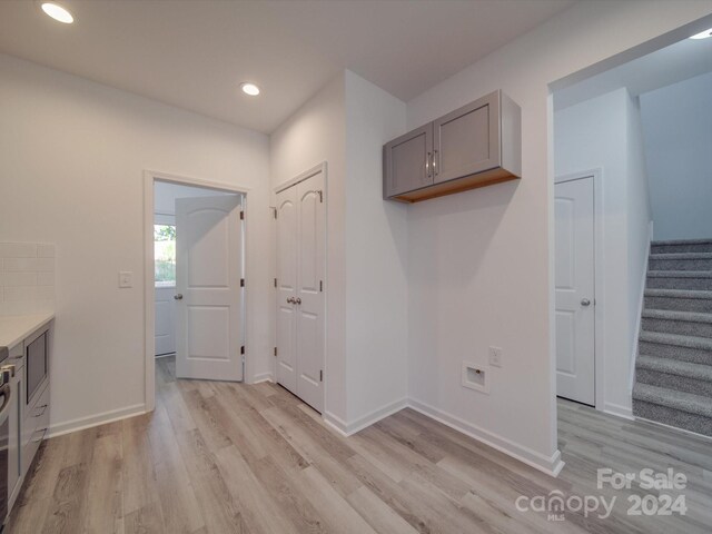 interior space with recessed lighting, light wood finished floors, and baseboards