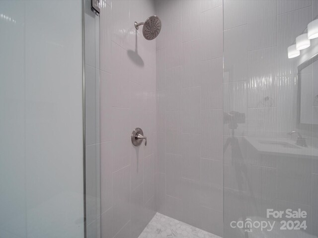 full bathroom with tiled shower