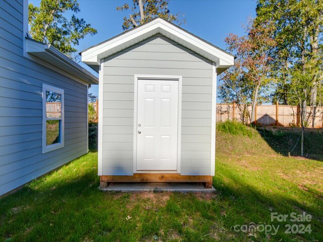 view of shed featuring fence