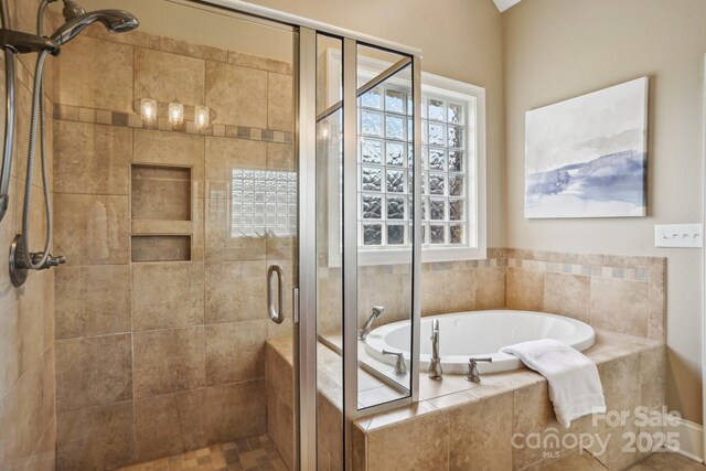 bathroom with a garden tub and a shower stall