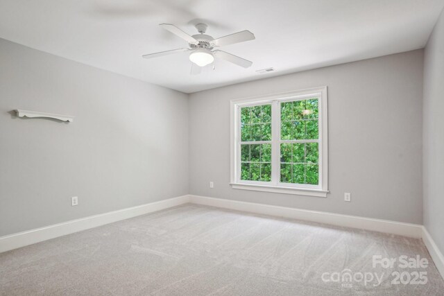 spare room featuring ceiling fan, baseboards, and carpet flooring