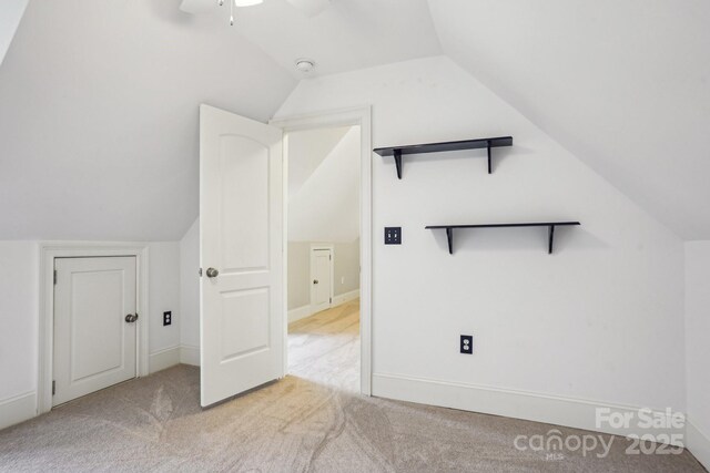bonus room with a ceiling fan, carpet, and lofted ceiling