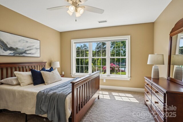 bedroom featuring visible vents, ceiling fan, light carpet, and baseboards