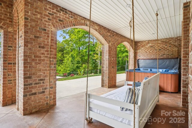 view of patio / terrace featuring a hot tub