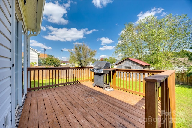 wooden terrace featuring a yard