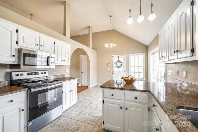 kitchen featuring appliances with stainless steel finishes, hanging light fixtures, white cabinetry, and light tile patterned floors