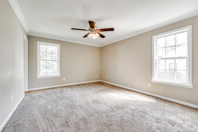 empty room with light colored carpet, crown molding, and a textured ceiling