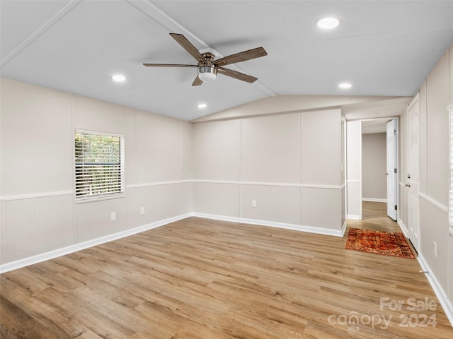 unfurnished room with light wood-type flooring, vaulted ceiling, and ceiling fan