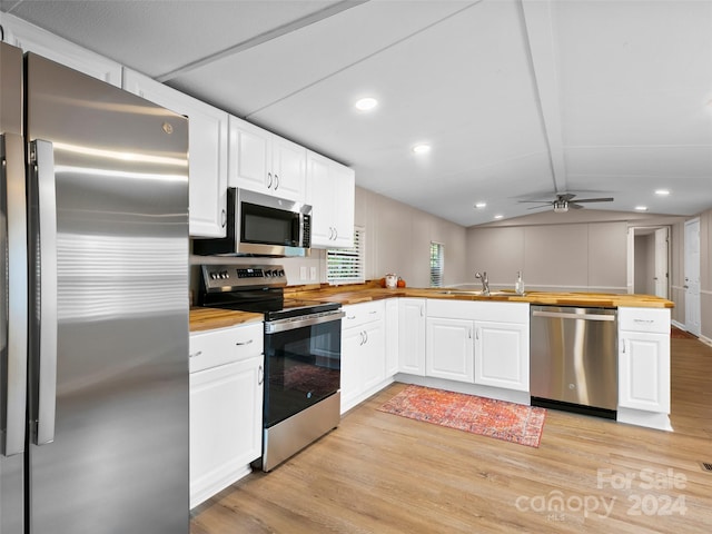 kitchen with wooden counters, light wood-type flooring, white cabinets, and stainless steel appliances