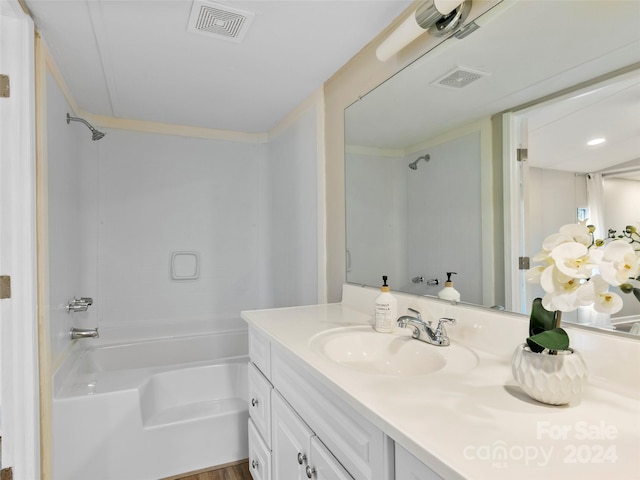 bathroom with hardwood / wood-style floors, vanity, and tub / shower combination