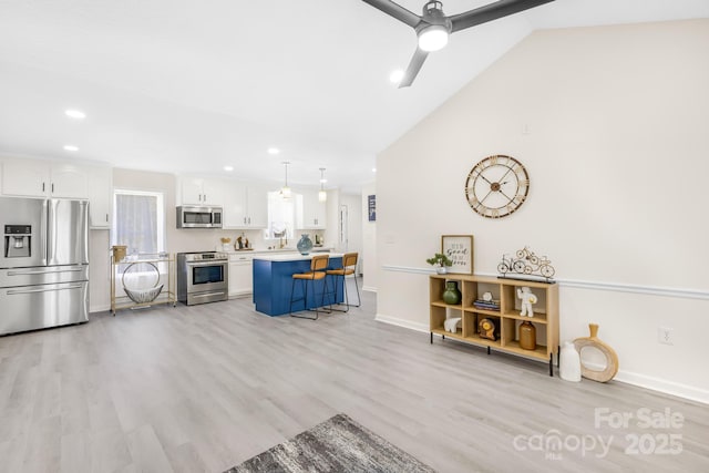 living room featuring ceiling fan, high vaulted ceiling, and light wood-type flooring