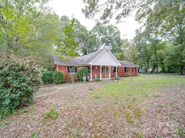 ranch-style house featuring a porch and a front yard