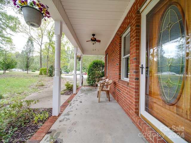 view of patio with ceiling fan and a porch