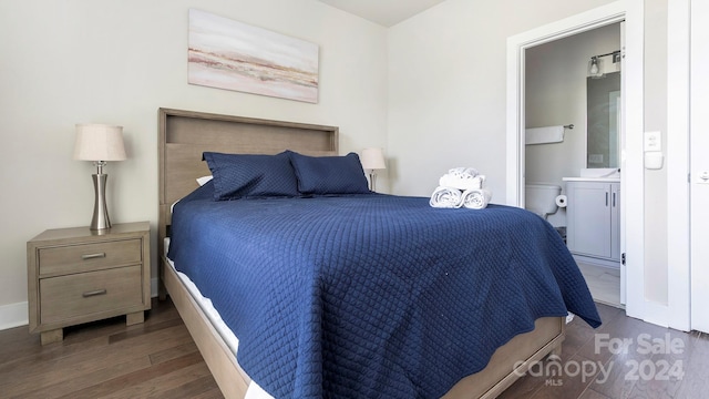 bedroom featuring dark wood-type flooring and connected bathroom