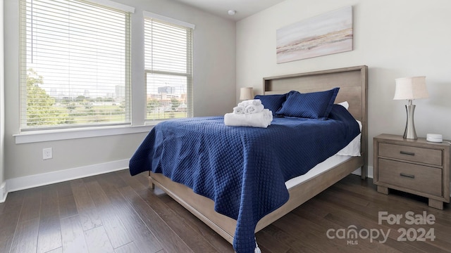 bedroom with dark hardwood / wood-style floors