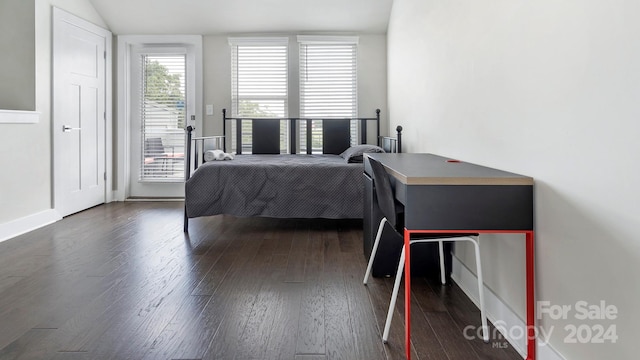 bedroom featuring dark wood-type flooring, access to outside, and lofted ceiling