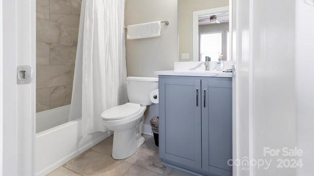 full bathroom with shower / bath combo, vanity, and toilet