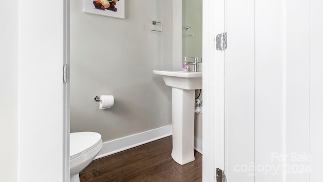 bathroom featuring hardwood / wood-style flooring and toilet