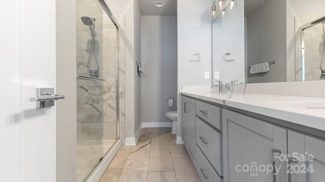 bathroom featuring vanity, toilet, and an enclosed shower