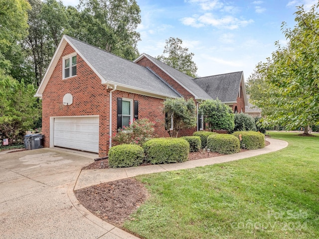 view of home's exterior featuring a yard and a garage