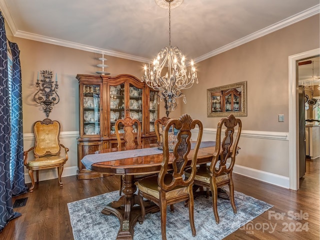 dining space with crown molding, dark wood-type flooring, and a notable chandelier