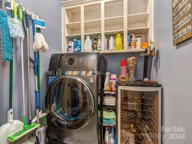 clothes washing area featuring beverage cooler and washer / dryer