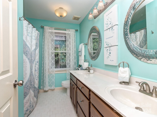 bathroom featuring vanity, toilet, and tile patterned floors