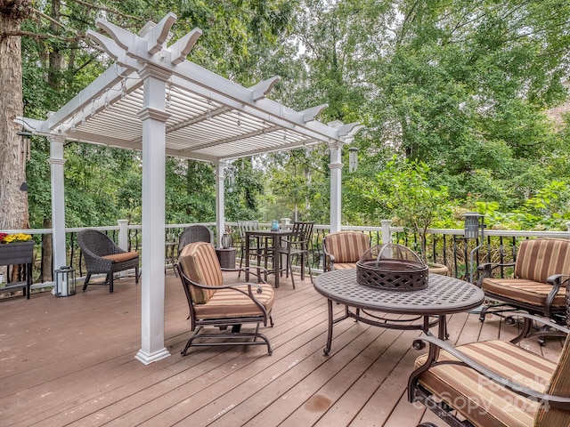 deck with a pergola and a fire pit