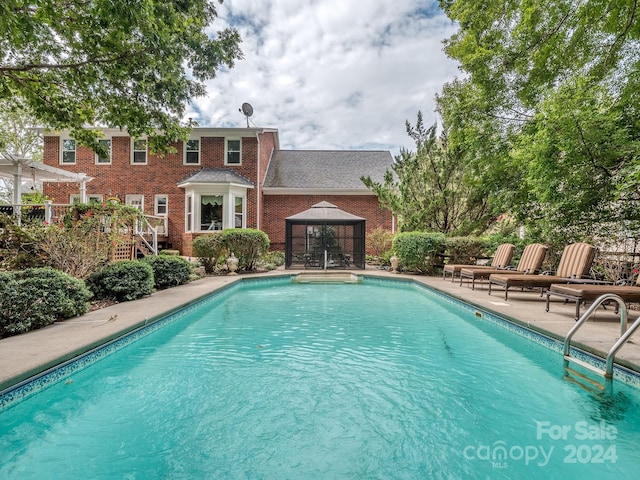 view of swimming pool with a gazebo