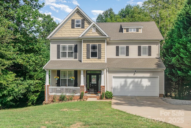 craftsman-style home featuring a porch, a garage, and a front yard