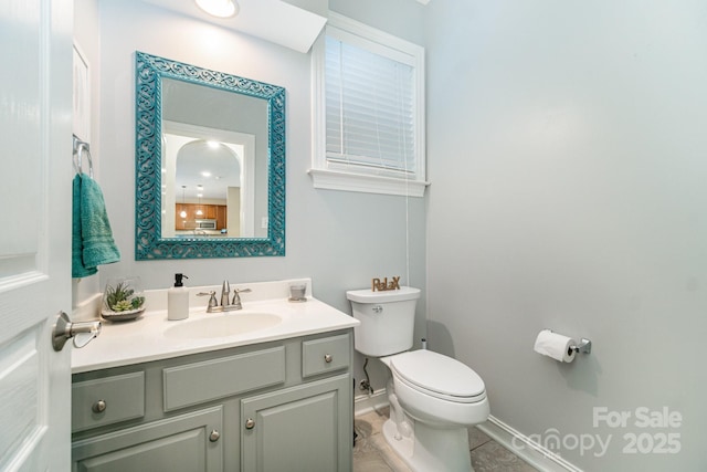 bathroom with vanity, toilet, and tile patterned flooring