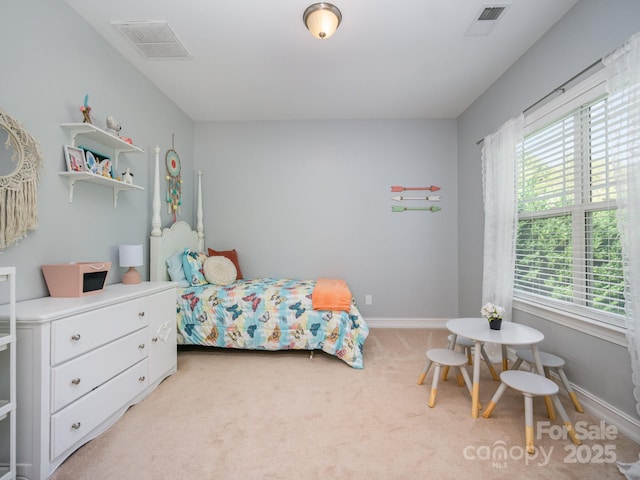 bedroom featuring multiple windows and light carpet