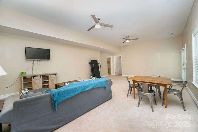 carpeted living room with ceiling fan and a healthy amount of sunlight