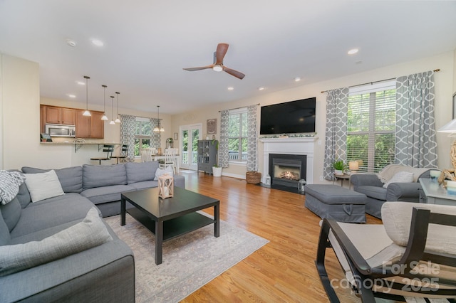 121 Canvasback Rd, Mooresville, NC 28117 - living area featuring ceiling fan, light wood-type flooring, a fireplace with flush hearth, recessed lighting, and a chandelier