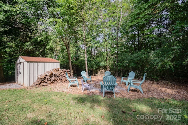 121 Canvasback Rd, Mooresville, NC 28117 - view of grassy yard featuring a storage shed and a fire pit