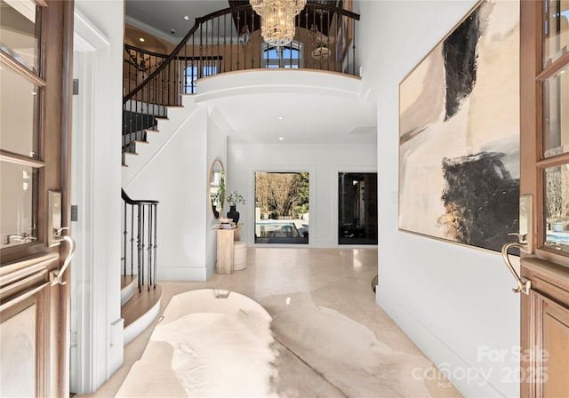 entrance foyer featuring an inviting chandelier and a high ceiling