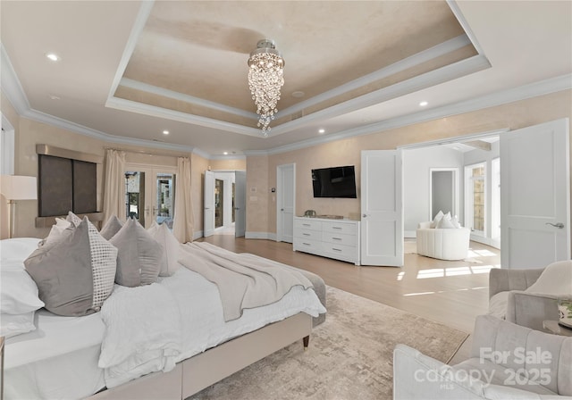 bedroom featuring french doors, ornamental molding, and a raised ceiling