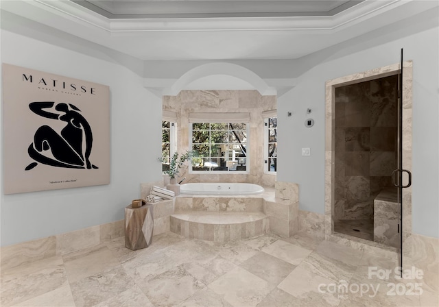 bathroom featuring a raised ceiling, ornamental molding, and shower with separate bathtub