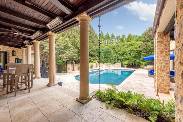 view of swimming pool featuring a patio and ceiling fan