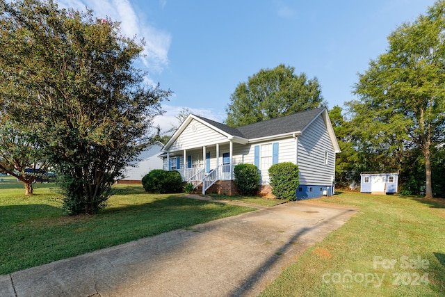 view of front facade featuring a storage shed, a front yard, and a porch