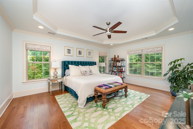 bedroom featuring a tray ceiling, ceiling fan, and crown molding