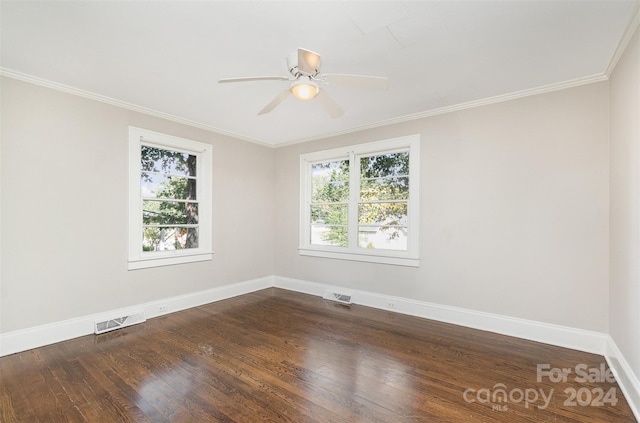 empty room featuring ceiling fan, crown molding, and dark wood-type flooring