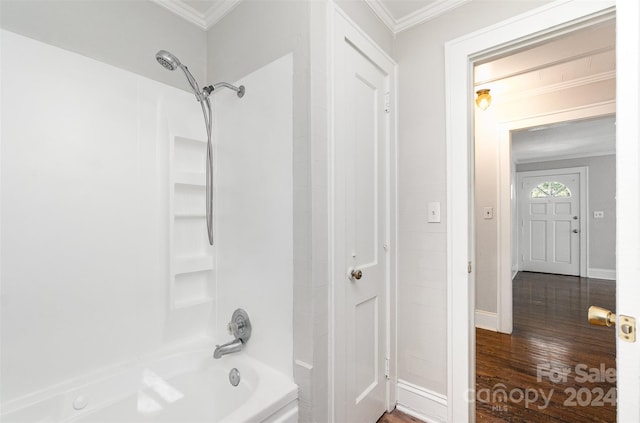 bathroom featuring ornamental molding, shower / bath combination, and hardwood / wood-style flooring