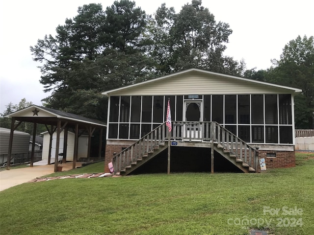 back of house with a gazebo, a sunroom, and a yard