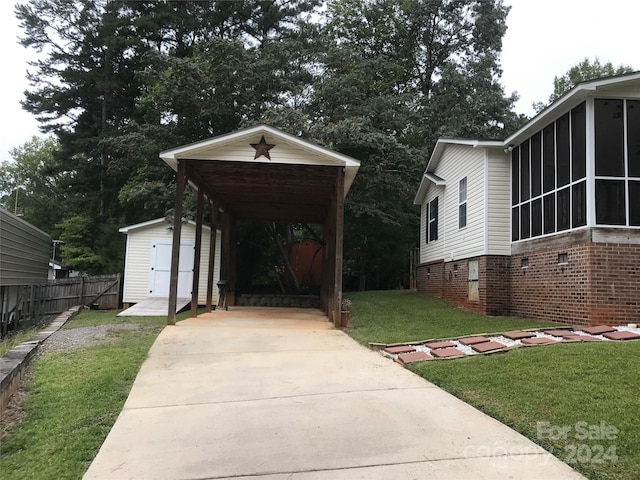 view of front facade with a storage shed, a carport, a front lawn, and a sunroom