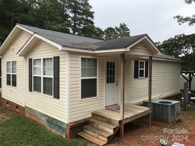 rear view of property featuring cooling unit