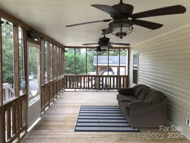 sunroom / solarium featuring ceiling fan