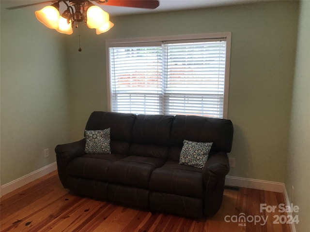 living room featuring ceiling fan and hardwood / wood-style floors